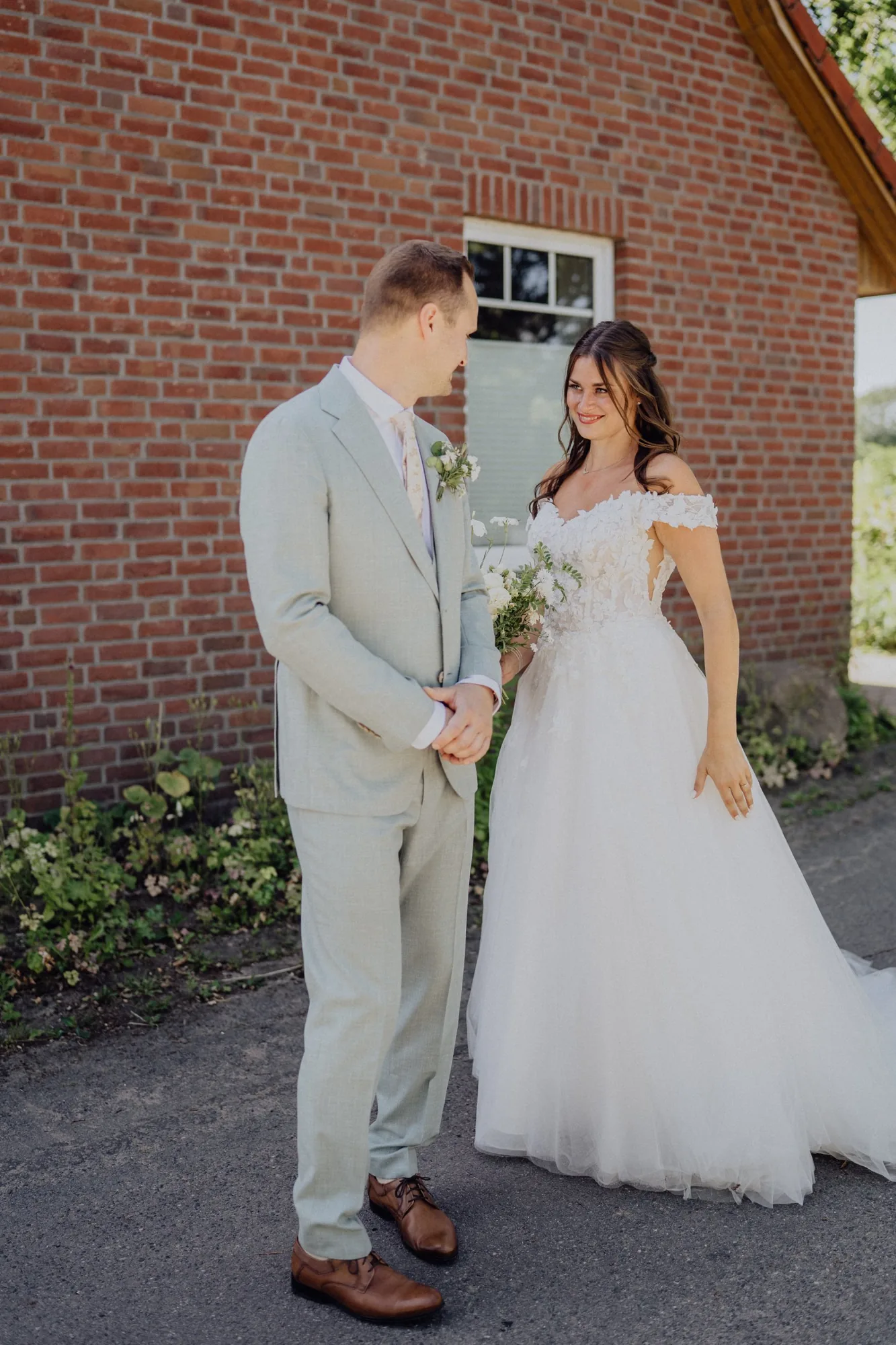 Franzi steht neben Tim, kurz bevor er sich zum First Look umdreht – Hochzeit Franzi & Tim, De Ole Schüün, Hüttblek