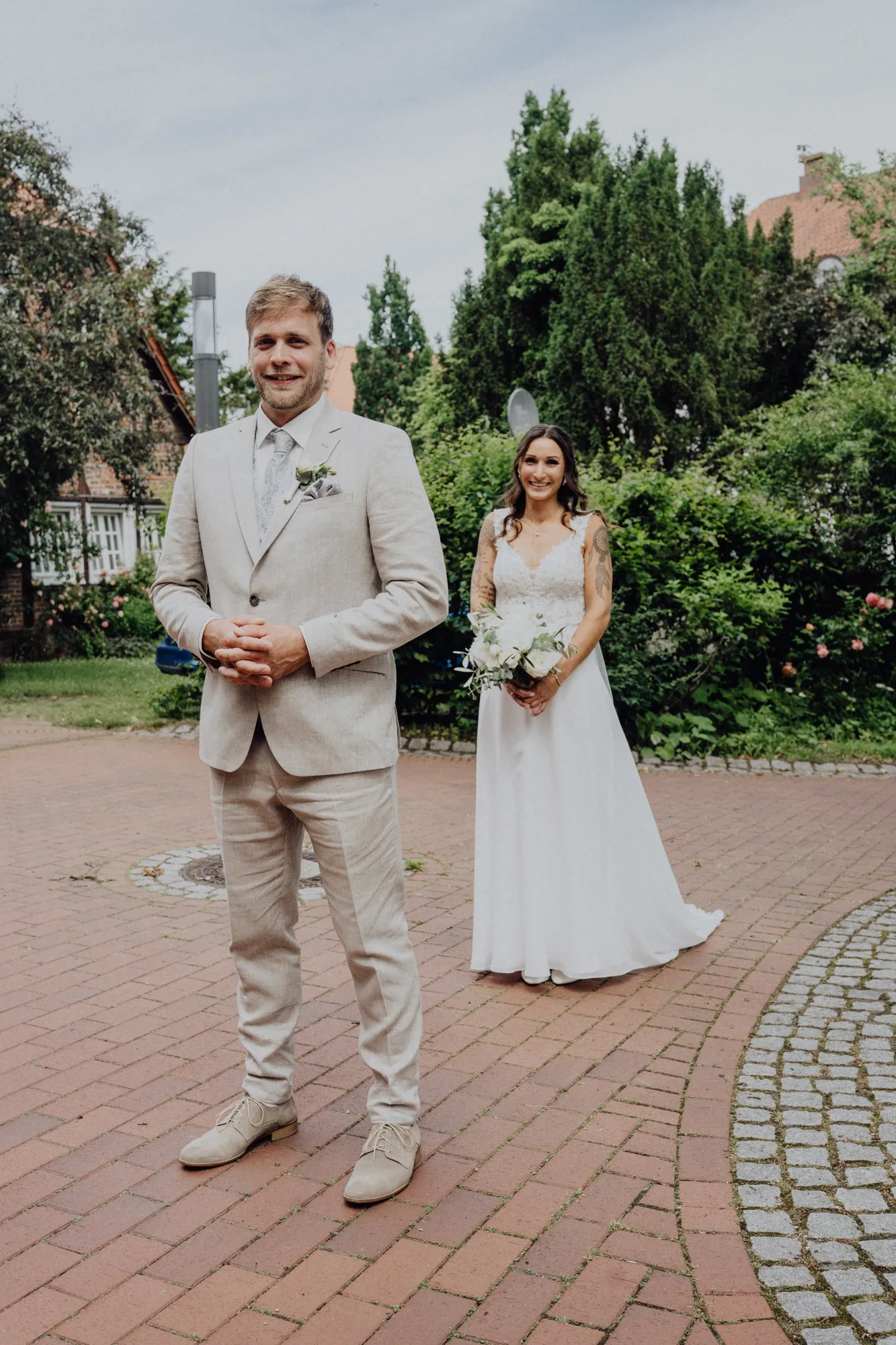 First Look vor der Kirche: Jannik wartet, Maria kommt von hinten – Hochzeit Maria & Jannik, Gut Pronstorf